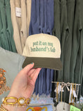 Put It On My Husband's Tab Trucker Hat